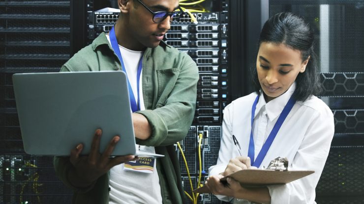 Two Gen Z workers in a server room