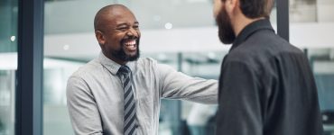 Two men shaking hands excited about promotion