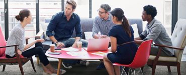 business people sitting at a table to discuss talent acquisition