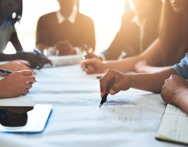 people collaborating about recruiting tools on a big table