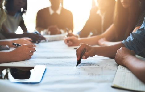 people collaborating about recruiting tools on a big table