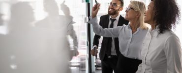 People drawing a map of ATS integrations on a whiteboard