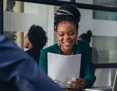 internal candidate being asked a question in a job interview looking at a piece of paper